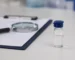 Clipboard checklist with magnifier and research vial — choosing a supplier